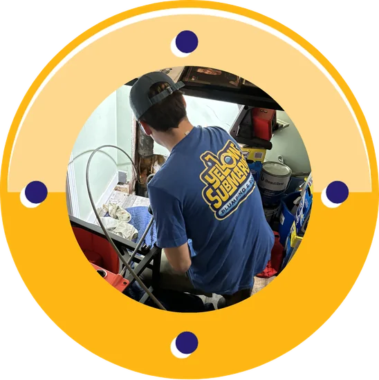 Yellow Submarine plumber cleaning a kitchen sink drain in Nanaimo